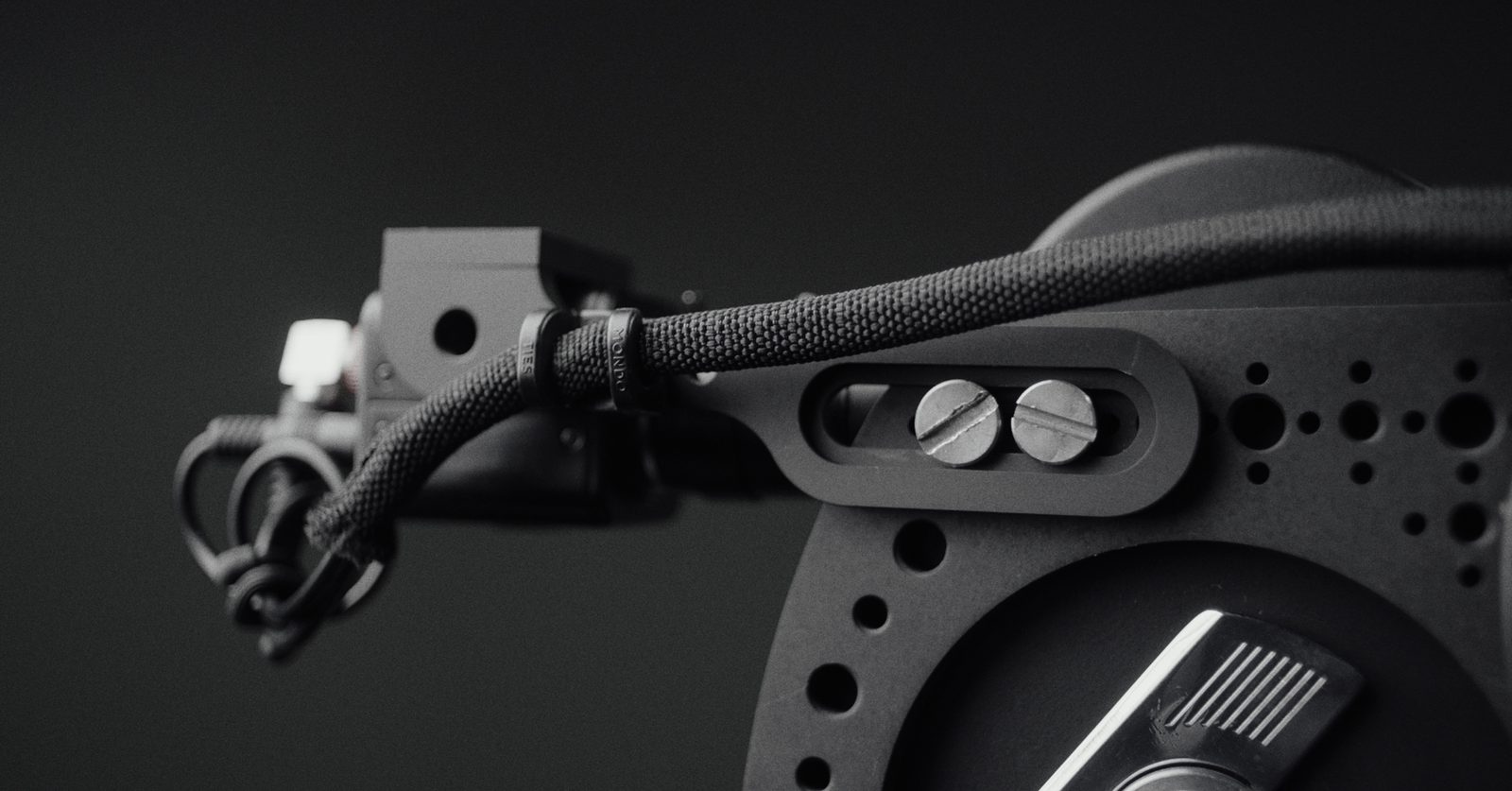 A CCTV video tap held on the strap with the cable tied off